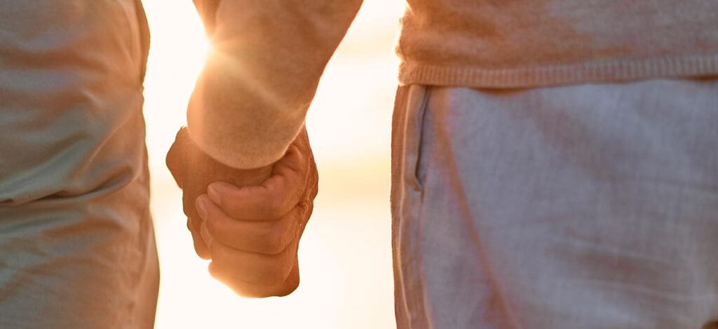 holding hands at the beach
